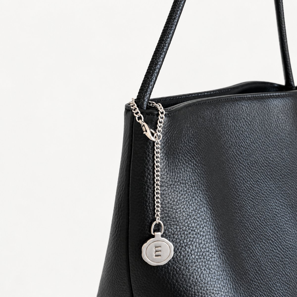 Cleo Smooth Bucket Bag in Black, metal charm and leather detail
