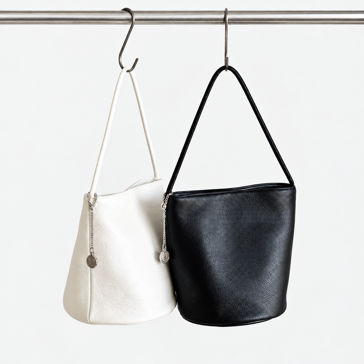 Cleo Smooth Bucket Bag in Black and Ivory, two colorways