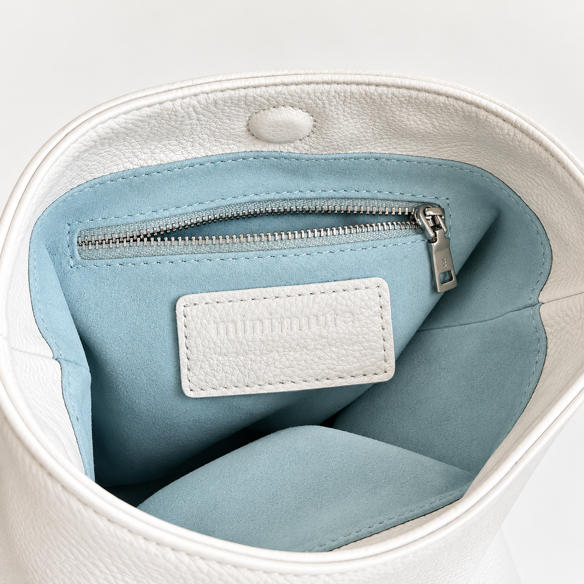 Cleo Smooth Bucket Bag in Ivory, interior pocket and lining detail