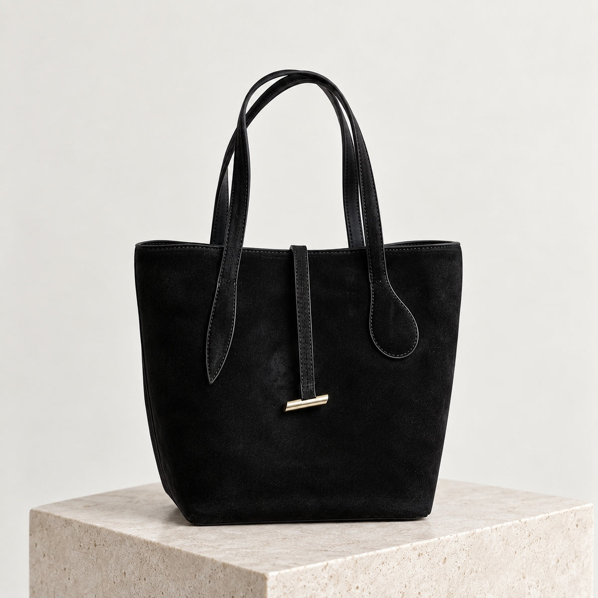 Selma Compact Tote in Black, front view on stone plinth