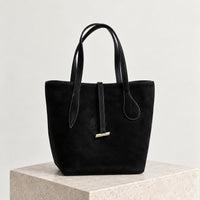 Selma Compact Tote in Black, front view on stone plinth