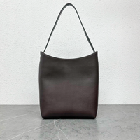 Arc Shoulder Bag in Dark Brown, front view with curved opening and single strap