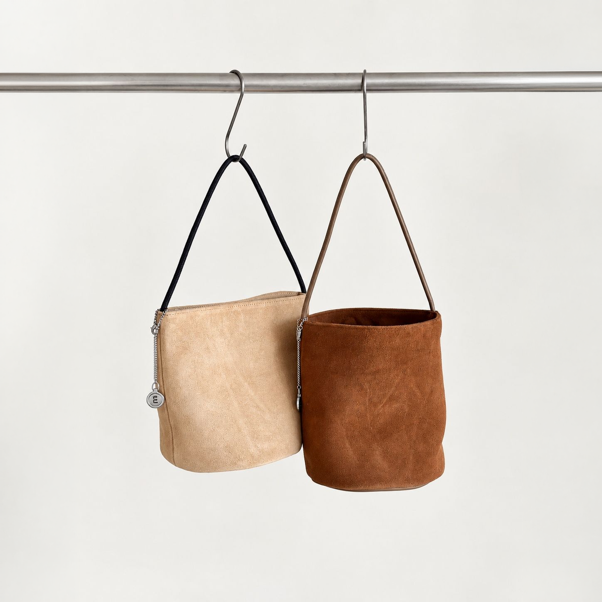 Camel and Brown Cleo Suede Bucket Bags, hanging view