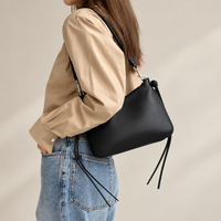 Noa Curve Shoulder Bag in Black, on model