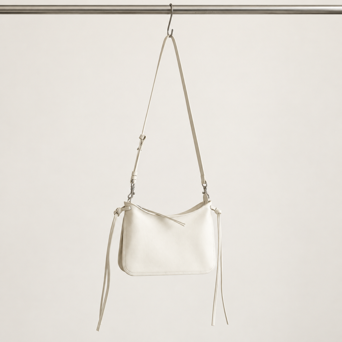 Noa Curve Shoulder Bag in Ivory, hanging view