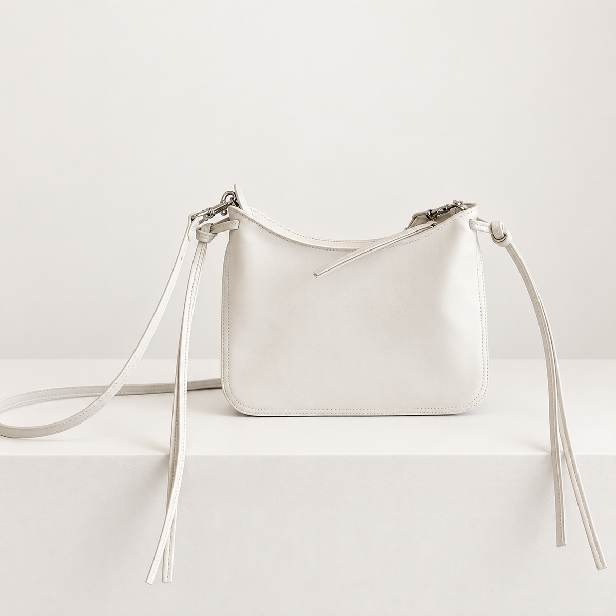Noa Curve Shoulder Bag in Ivory, studio front view