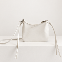 Noa Curve Shoulder Bag in Ivory, studio front view