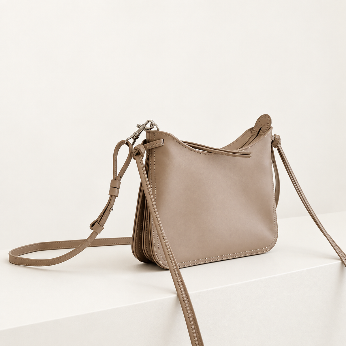 Noa Curve Shoulder Bag in Taupe, studio three-quarter view