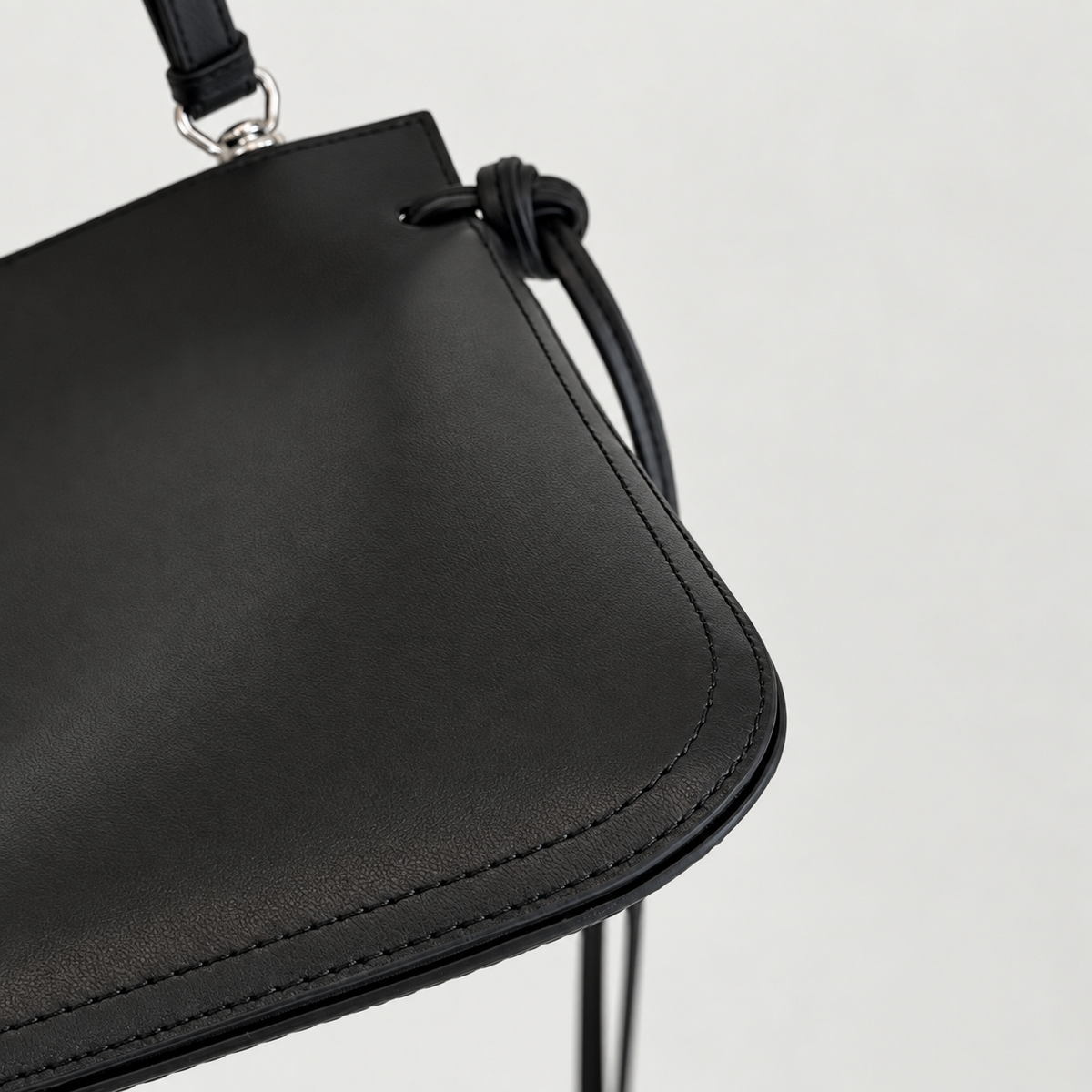 Tilda Tie Shoulder Bag in Black, rounded corner and stitching detail