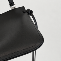 Tilda Tie Shoulder Bag in Black, rounded corner and stitching detail