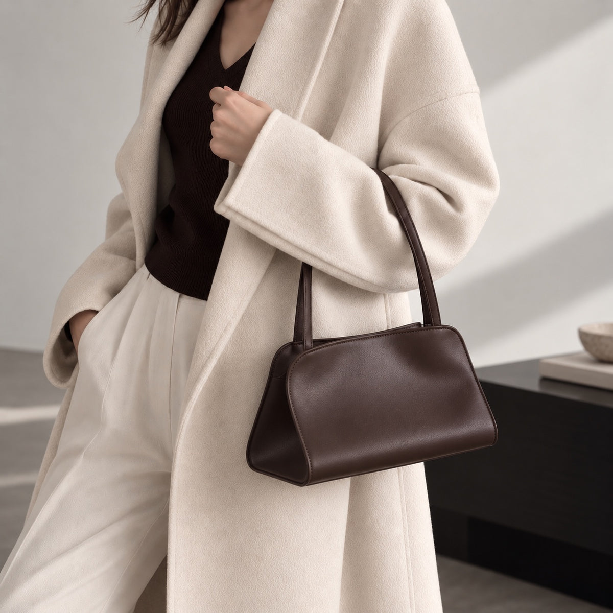 Odette Sculptural Shoulder Bag in Dark Brown, carried on arm